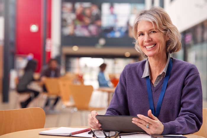 Female high school administrator working on a tablet